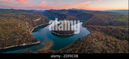 Monastery of Sant Pere de Casserres during sunset. The monastery is surrounded by the river Ter. Stock Photo