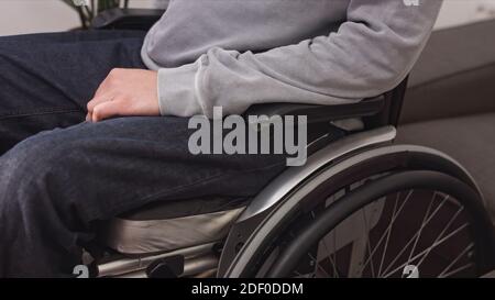 Close up of man on wheelchair at home in a living room. Stock Photo