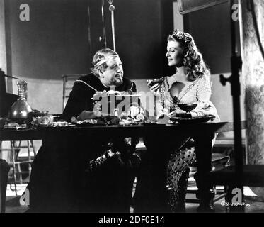 CHARLES LAUGHTON as King Herod and RITA HAYWORTH on set candid during filming of SALOME 1953 director WILLIAM DIETERLE story Jesse Lasky Jr. and Harry Kleiner gowns Jean Louis producers Buddy Adler and Rita Hayworth The Beckworth Corporation / Columbia Pictures Stock Photo