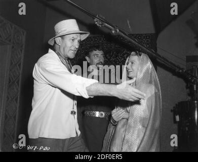 Director WILLIAM DIETERLE ARNOLD MOSS and RITA HAYWORTH on set candid during filming of SALOME 1953 director WILLIAM DIETERLE story Jesse Lasky Jr. and Harry Kleiner gowns Jean Louis producers Buddy Adler and Rita Hayworth The Beckworth Corporation / Columbia Pictures Stock Photo