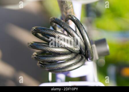 A closeup shot of a gray bicycle cable lock Stock Photo