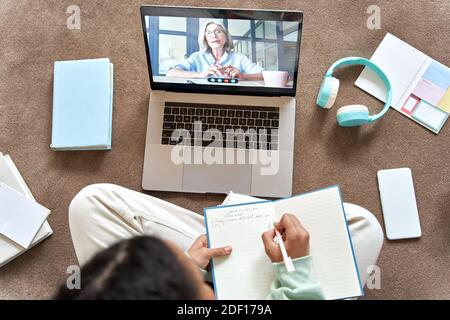 Teen school girl distance learning online video call class with remote tutor. Stock Photo