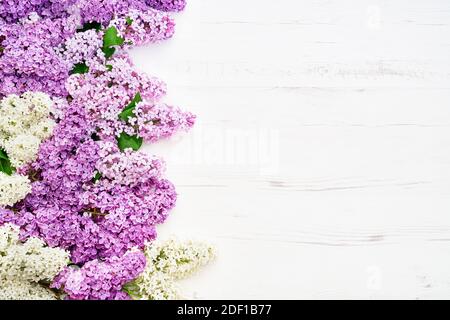 Floral pattern of pink lilac branches, flowers background. Flat lay, top view. Greeting card Stock Photo
