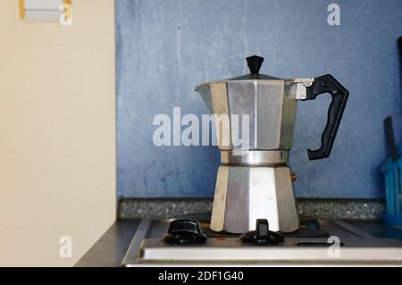 A beautiful shot of an old metal kettle on the oven in the kitchen Stock Photo