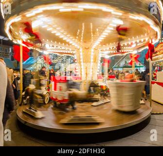 Graz, Austria - November 22, 2019: Vintage carousel at Christmas market in Hauptplatz (main square). Long exposure photography for movement effect. Stock Photo