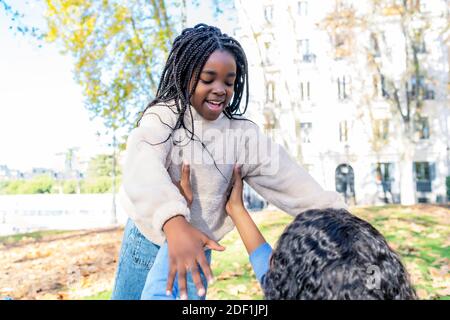 mother hugging her daughter in the park Stock Photo