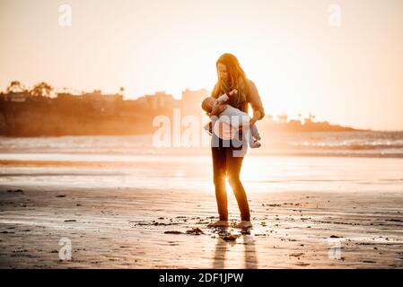 Nude mother breastfeeding infant son Stock Photo - Alamy