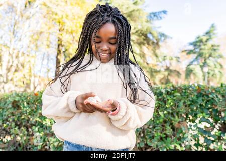 beautiful african girl disinfecting her hands to avoid covid19 Stock Photo