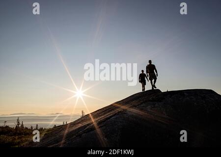 Two hikers walk above tree line on Moxie Bald Mountain in Maine. Stock Photo