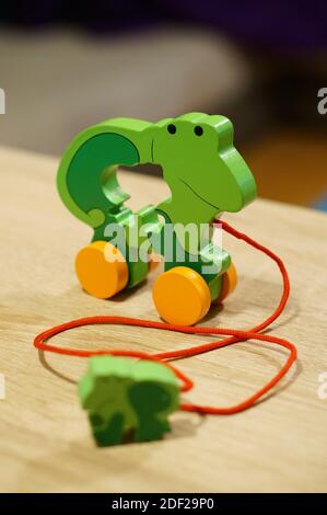 A vertical shot of a green frog wooden toy for kids Stock Photo