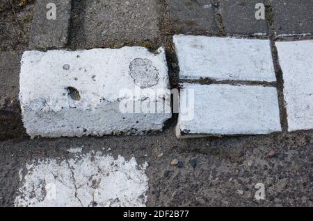 A top view shot of a few white painted bricks on a path Stock Photo