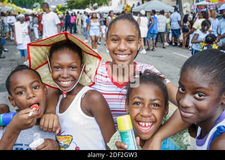 Miami Florida,Coconut Grove Grand Avenue Bahamas Goombay Festival,event community Black African Africans girls kids friends,smiling laughing, Stock Photo