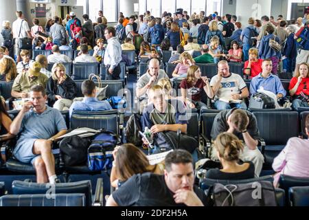 New Jersey Newark Liberty International Airport EWR,inside interior gate passenger passengers connecting flight delayed,man woman female couples wait Stock Photo