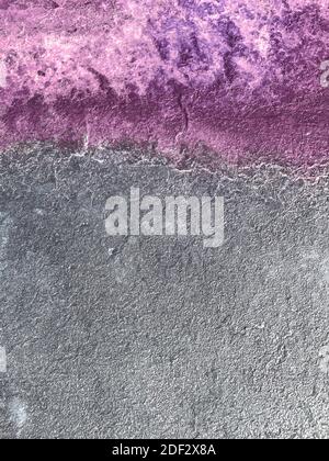 Grey concrete surface with splash of Amethyst colored paint. Abstract universal backdrop with text space Stock Photo