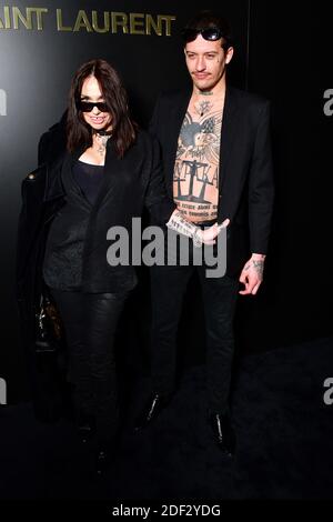 Beatrice Dalle and Paul Bichet attend the Saint Laurent show as part