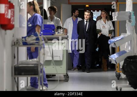 French President Emmanuel Macron, flanked by AP-HP President Martin Hirsch and French Health minister Olivier Veran, meets with medical staff as he visits the Pitie-Salpetriere hospital in Paris on February 27, 2020 where the first French victim of COVID-19 passed away the day before. France has so far registered 18 infections and two deaths, a 60 years-old French citizen and a 80 years old Chinese tourist, as European governments scramble to contain a slew of new coronavirus cases popping up across the continent. Photo by Stephane Lemouton/ABACAPRESS.COM Stock Photo