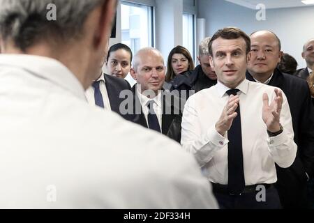 French President Emmanuel Macron, flanked by AP-HP President Martin Hirsch and French Health minister Olivier Veran, meets with medical staff as he visits the Pitie-Salpetriere hospital in Paris on February 27, 2020 where the first French victim of COVID-19 passed away the day before. France has so far registered 18 infections and two deaths, a 60 years-old French citizen and a 80 years old Chinese tourist, as European governments scramble to contain a slew of new coronavirus cases popping up across the continent. Photo by Stephane Lemouton/ABACAPRESS.COM Stock Photo