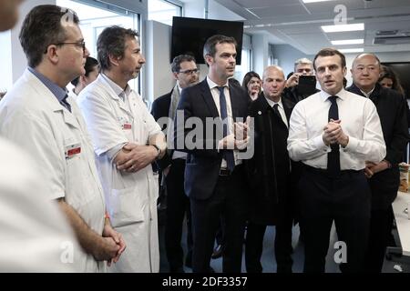 French President Emmanuel Macron, flanked by AP-HP President Martin Hirsch and French Health minister Olivier Veran, meets with medical staff as he visits the Pitie-Salpetriere hospital in Paris on February 27, 2020 where the first French victim of COVID-19 passed away the day before. France has so far registered 18 infections and two deaths, a 60 years-old French citizen and a 80 years old Chinese tourist, as European governments scramble to contain a slew of new coronavirus cases popping up across the continent. Photo by Stephane Lemouton/ABACAPRESS.COM Stock Photo