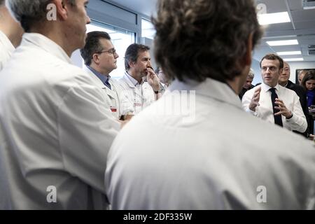 French President Emmanuel Macron, flanked by AP-HP President Martin Hirsch and French Health minister Olivier Veran, meets with medical staff as he visits the Pitie-Salpetriere hospital in Paris on February 27, 2020 where the first French victim of COVID-19 passed away the day before. France has so far registered 18 infections and two deaths, a 60 years-old French citizen and a 80 years old Chinese tourist, as European governments scramble to contain a slew of new coronavirus cases popping up across the continent. Photo by Stephane Lemouton/ABACAPRESS.COM Stock Photo