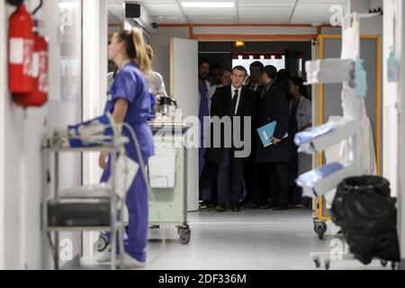 French President Emmanuel Macron, flanked by AP-HP President Martin Hirsch and French Health minister Olivier Veran, meets with medical staff as he visits the Pitie-Salpetriere hospital in Paris on February 27, 2020 where the first French victim of COVID-19 passed away the day before. France has so far registered 18 infections and two deaths, a 60 years-old French citizen and a 80 years old Chinese tourist, as European governments scramble to contain a slew of new coronavirus cases popping up across the continent. Photo by Stephane Lemouton/ABACAPRESS.COM Stock Photo