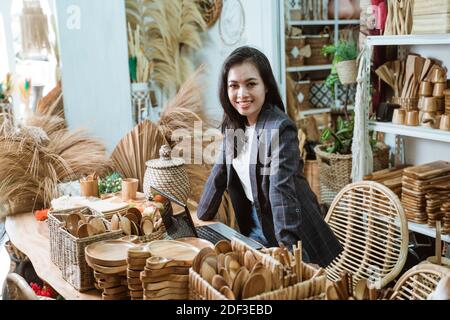 attractive asian business owner at her art and craft store selling goods made of natural product Stock Photo