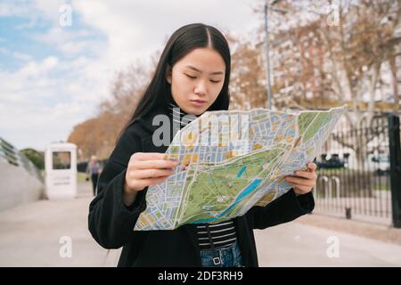 Young asian woman with a map. Stock Photo