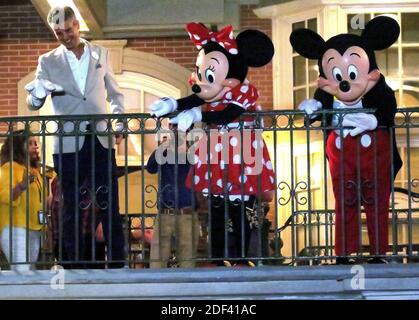 NO FILM, NO VIDEO, NO TV, NO DOCUMENTARY - With Minnie and Mickey, Walt Disney World president Josh D'Amaro waves to guests gathered on Main Street USA, in the Magic Kingdom in the final minutes before the park closed, Sunday night, March 15, 2020, in Lake Buena Vista, Fla. Walt Disney World announced that all their Florida parks will be closed for the rest of March as a result of the coronavirus pandemic. Photo by Joe Burbank/Orlando Sentinel/TNS/ABACAPRESS.COM Stock Photo