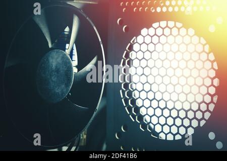 A cooling system of PC. A fan of central processing or the CPU on motherboard cooler pc system unit. Lens glare and toned photo. Stock Photo