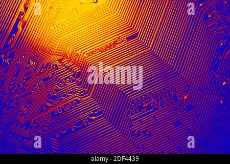 Blue and red electronic mother board circuit close up macro background. Stock Photo