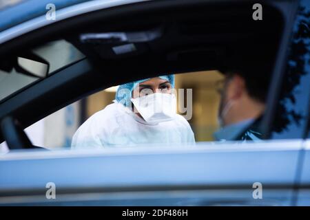 People are tested with cotton swabs inside their nostrils in their car at a drive-through coronavirus COVID-19 testing center by BioGroup laboratory in Neuilly sur Seine near Paris, France on March 25, 2020. Photo by Raphael Lafargue/ABACAPRESS.COM Stock Photo