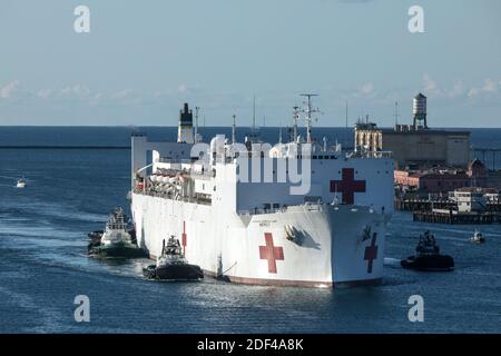 In this photo released by the United States Navy, the Military Sealift Command hospital ship USNS Mercy (T-AH 19) arrives in Los Angeles, CA, USA, on March 27, 2020. Mercy deployed in support of the nation's COVID-19 response efforts, and will serve as a referral hospital for non-COVID-19 patients currently admitted to shore-based hospitals. This allows shore base hospitals to focus their efforts on COVID-19 cases. One of the Department of Defense's missions is Defense Support of Civil Authorities. DOD is supporting the Federal Emergency Management Agency, the lead federal agency, as well as s Stock Photo