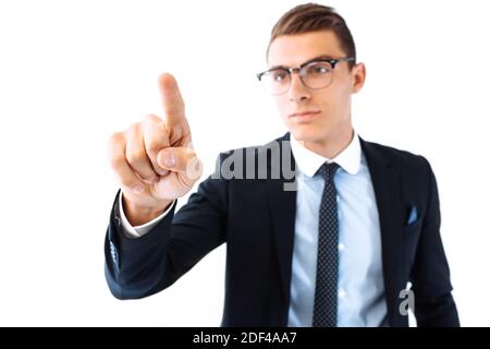 business businessman in glasses and suit, touching the imaginary screen, presses the button on a white background Stock Photo