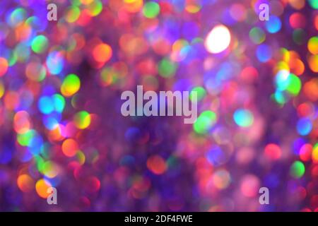 Christmas background, garland in blur. Glowing and festive rainbow light circles created in camera and bokeh lens. Christmas fairy lights are defocuse Stock Photo