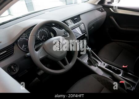 The front of the vehicle interior with a driver's seat, dashboard and steering wheel. Stock Photo