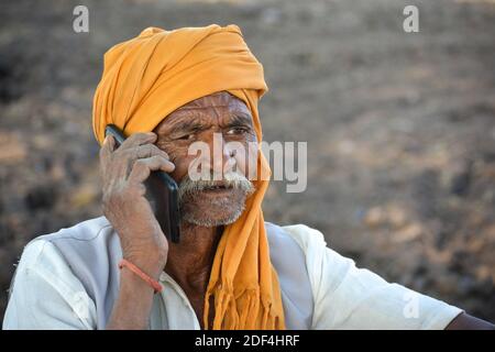 TIKAMGARH, MADHYA PRADESH, INDIA - NOVEMBER 23, 2020: Indian old man talking on mobile phone. Stock Photo