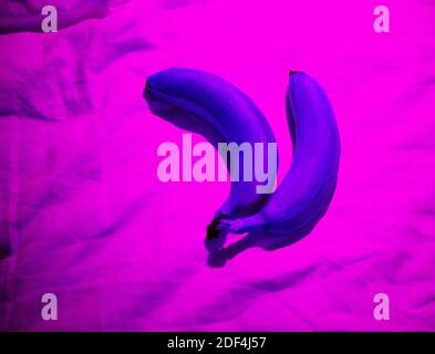 Photo of purple bananas on a pink background Stock Photo