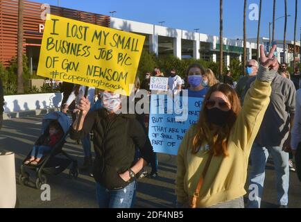 Long Beach, California, USA. 3rd Dec 2020. Protesters march against new COVID-19 restaurant restrictions on Pacific Coast Highway in Long Beach, California on Wednesday, December 2, 2020. The protest march led by two local businessmen is the latest in a string of organized events to push against stricter health orders regulating restaurants in California's purple tier, which indicates widespread coronavirus infections and is the most stringent for business operations. Credit: UPI/Alamy Live News Stock Photo
