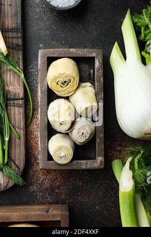 Pickled artichokes with oil, on old rustic background, top view Stock Photo