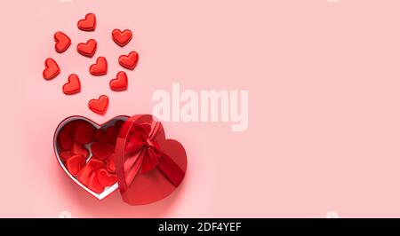 Valentine's Day greeting card with open red box and hearts on pink background with copy space. View from above. Flat lay. Stock Photo