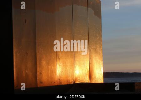 Ayr, Ayrshire, Scotland, UK Abstract Sunlight on metal sculpture at Ayr beach. Donald Urquhart Gateway sculpture on the seafront at Ayr beach marks one end of the River Ayr Way, Ayr, South Ayrshire, Scotland. The structure was made from coal resin obtained from Glenbuck, at the path’s starting point. Stock Photo