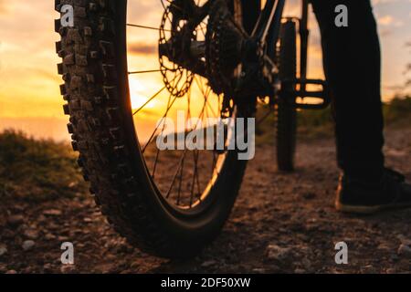 Mountain bike rear wheel detail. Back shot of mountain bike on sunset. Stock Photo