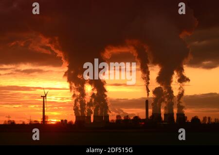 giant cooling towers and windmill at drax power station at sunset united kingdom Stock Photo