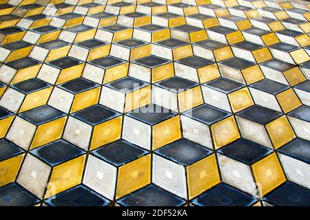 Geometry cubes optical illusion floor in the park of Tbilisi. Geometry figure background. Yellow and black. Stock Photo