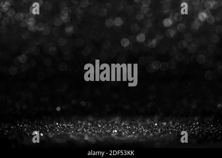Black friday bokeh background. Elegant dark blur layout design. Silver and black glitter place on table with spotlight. Luxury abstract banner with co Stock Photo