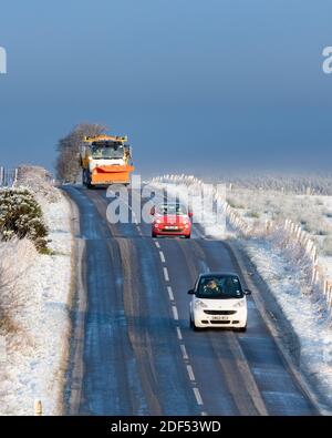 Balfron, Stirlingshire, Scotland, UK. 3rd Dec, 2020. UK weather - snow and sunshine in Balfron Stirlingshire.  Pictured: snow plough and traffic on the A875 road Credit: Kay Roxby/Alamy Live News Stock Photo