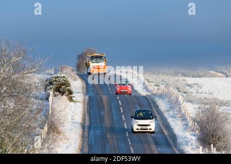 Balfron, Stirlingshire, Scotland, UK. 3rd Dec, 2020. UK weather - snow and sunshine in Balfron Stirlingshire.  Pictured: snow plough and traffic on the A875 road Credit: Kay Roxby/Alamy Live News Stock Photo