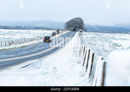 Balfron, Stirlingshire, Scotland, UK. 3rd Dec, 2020. UK weather - early morning snow in Balfron Stirlingshire on the A875 road leaving the village heading north Credit: Kay Roxby/Alamy Live News Stock Photo