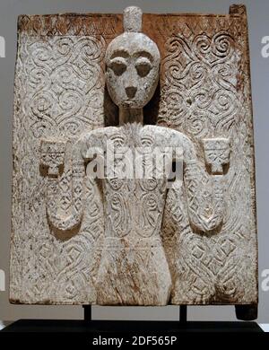 Wooden door of a tomb with human figure. Sa'dan Toraja people. Guardian figure on this door represents a warrior, as indicated by his topknot and tattoos. 18th or 19th century. Wood and dead lichen. South Sulawesi, Indonesia. Dallas Museum of Art. State of Texas. United States. Stock Photo