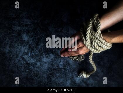 Tied hands of a woman Stock Photo