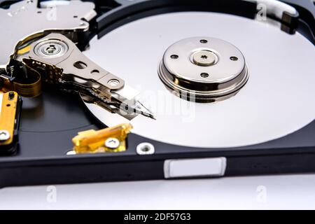 Internal parts of a hard disk isolated on a white background. Close up of Hard disk drive inside view. Stock Photo